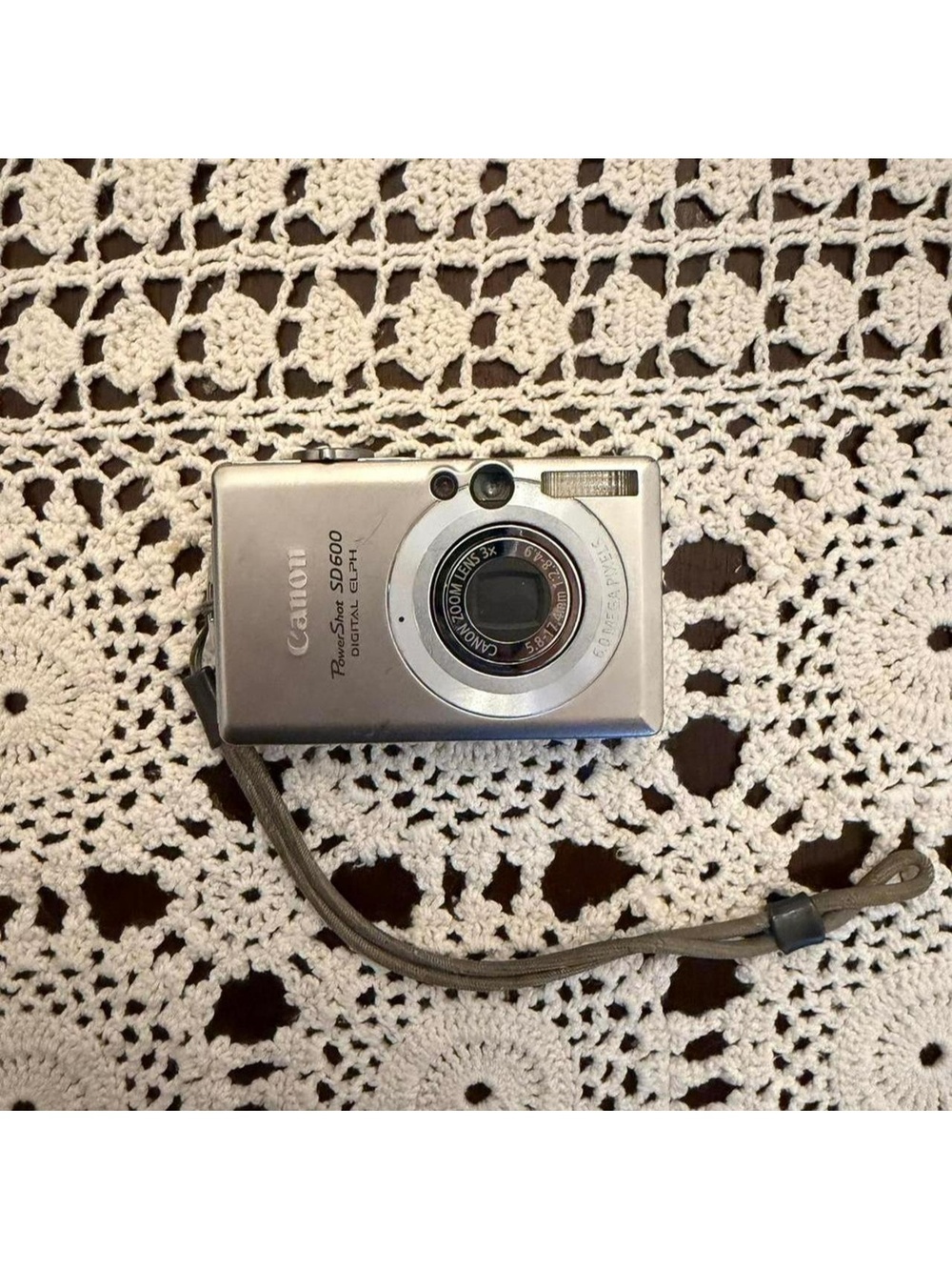 Silver Canon PowerShot SD600 digital camera with charger